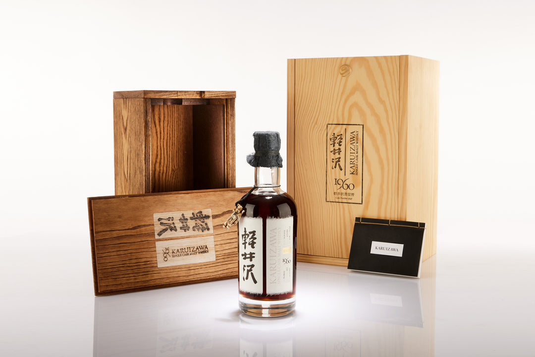 Bottle of Karuizawa whisky with wooden box on a white background